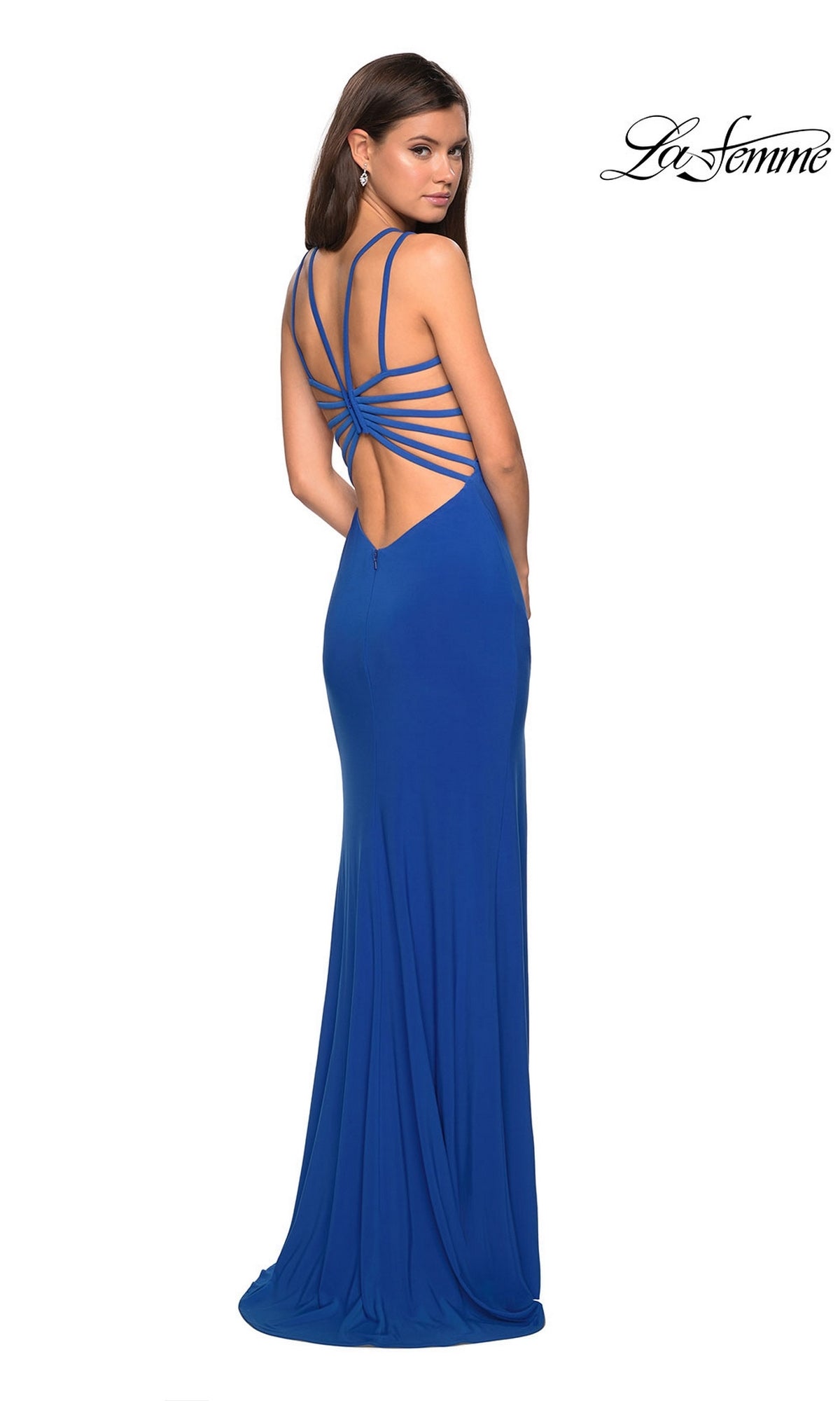 Woman wearing the La Femme Statement-Back Long Prom Dress 27072, a floor-length royal blue gown with a fitted silhouette and strappy open back, standing and looking over her shoulder.